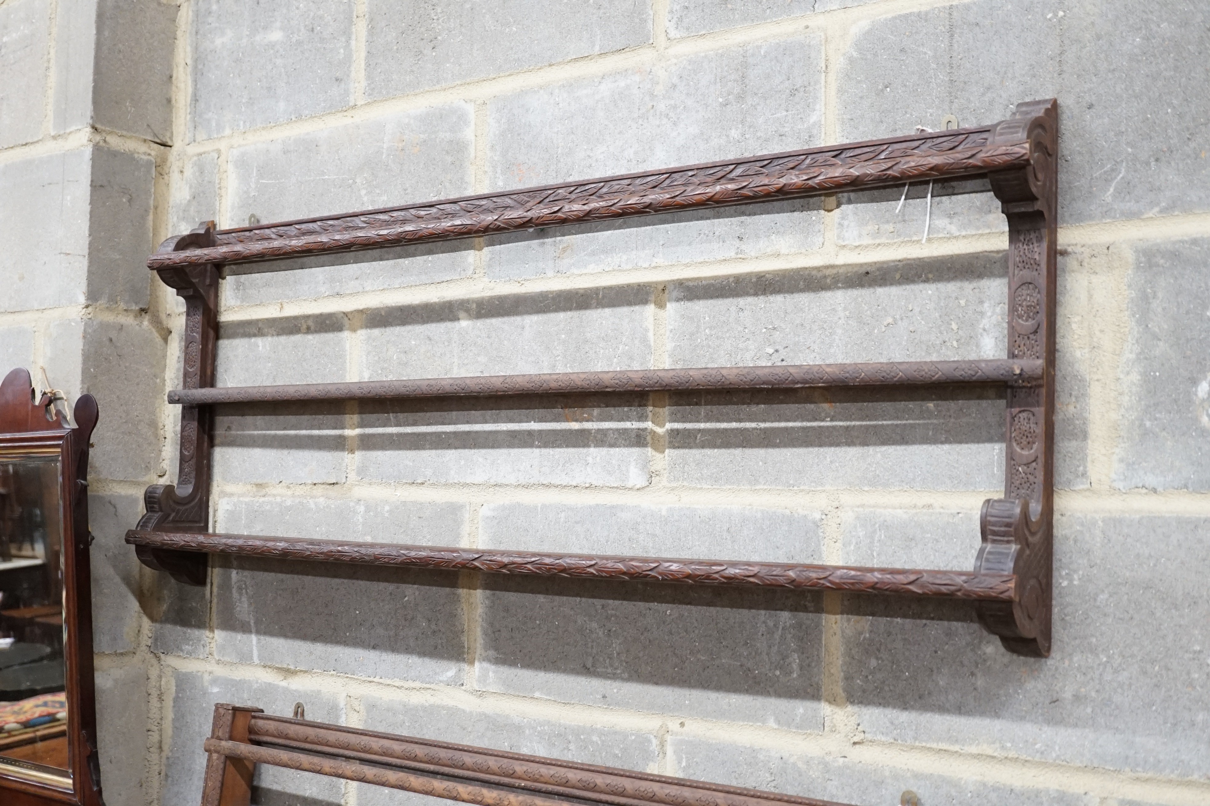 Two Continental carved beech plate racks, length 120cm, height 105cm